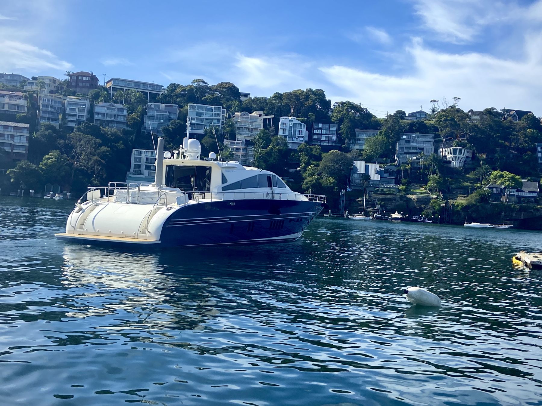 A motor yacht lying at anchor in calm water