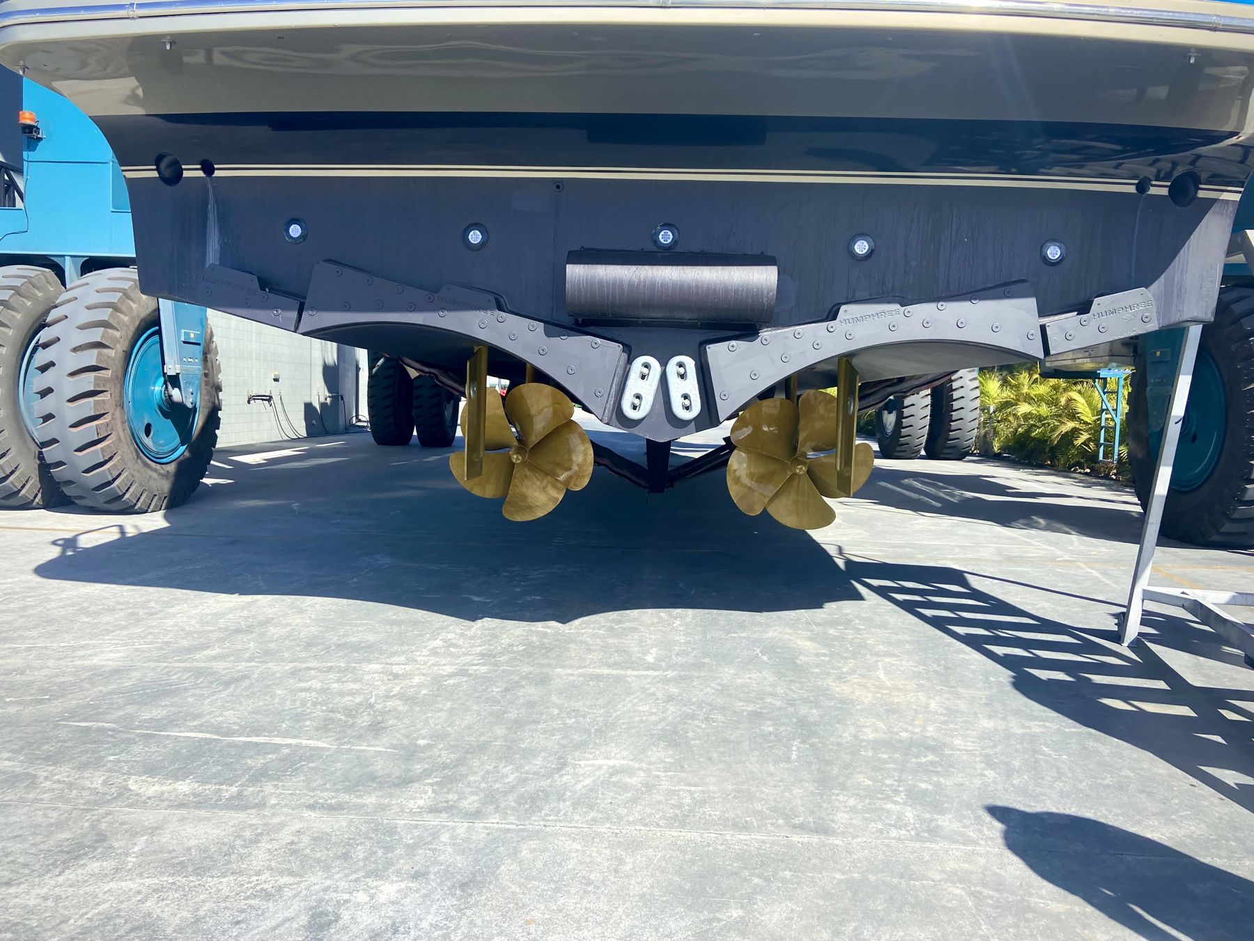 Twin propellers, shafts and rudders under a motor yacht on the hardstand