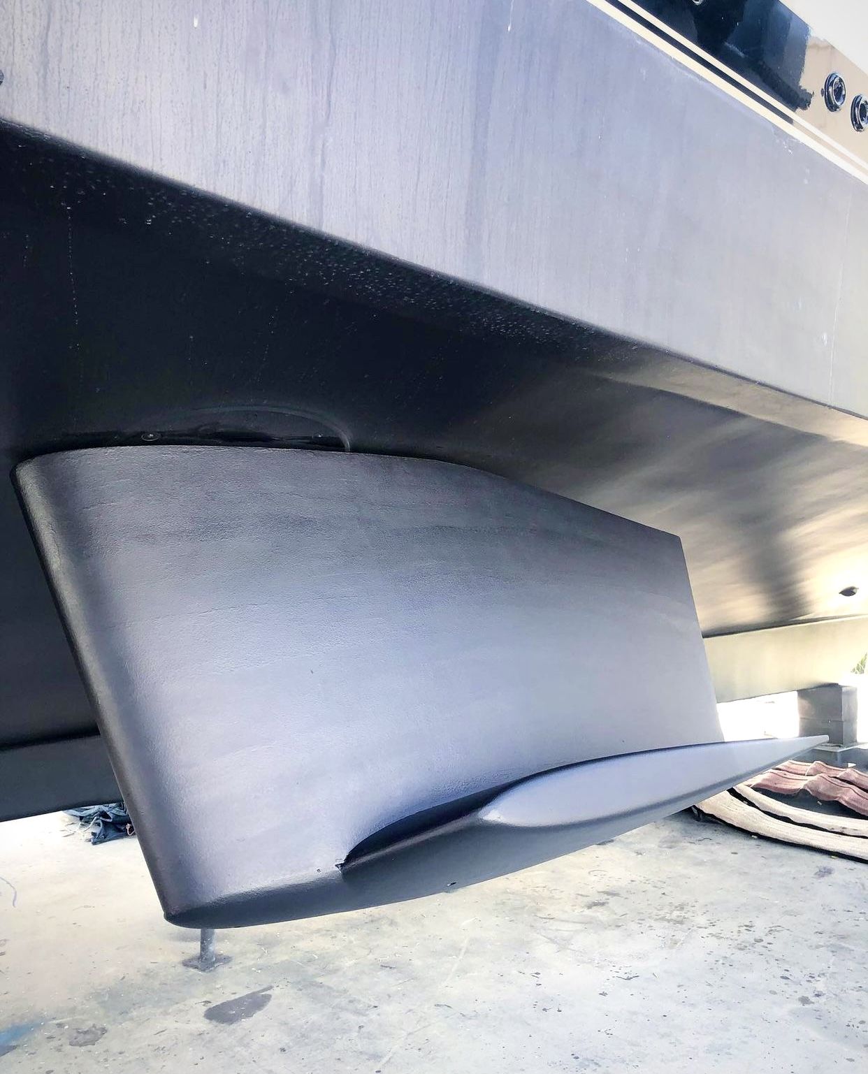 A stabiliser fin on the hull of a motor yacht out of the water